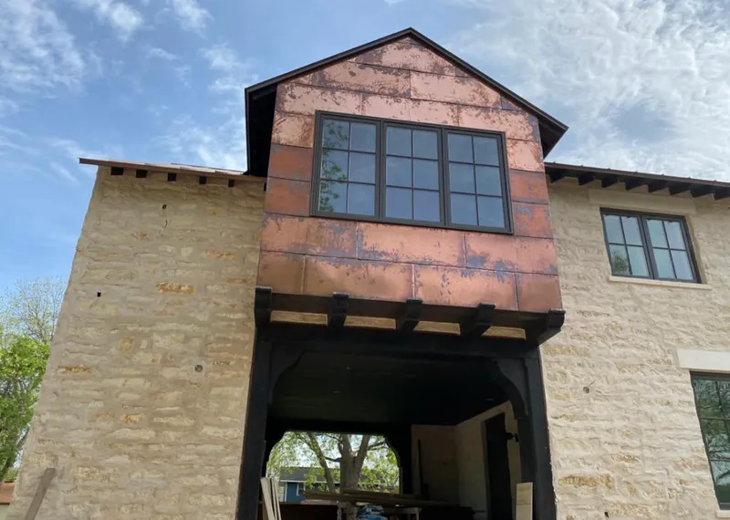 Copper metal panel facade on a stone building for Roof Repair in Gatesville